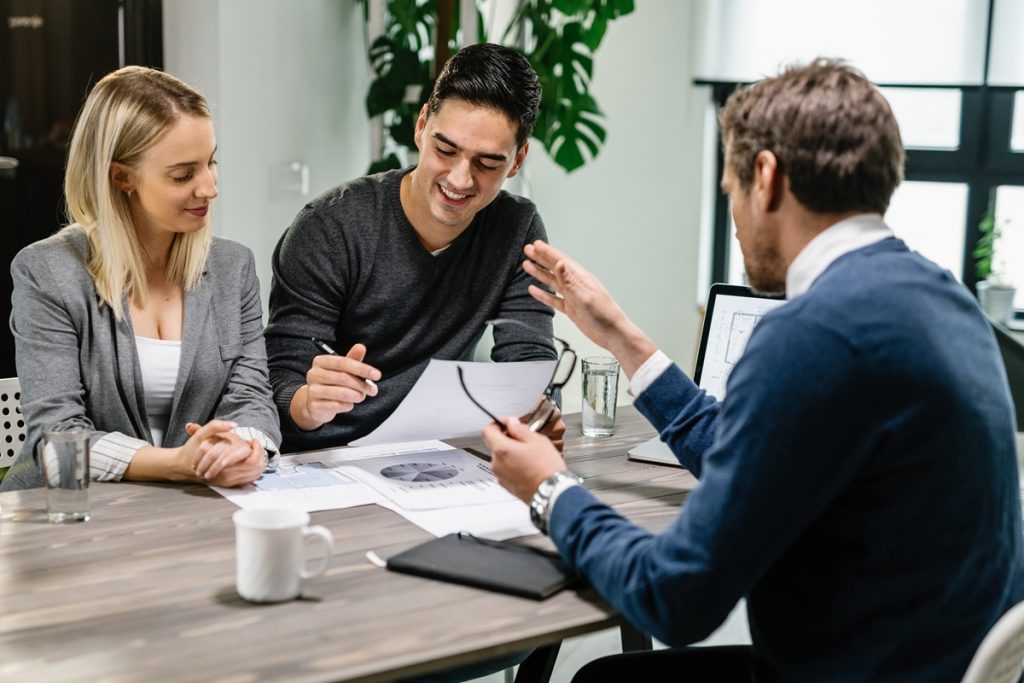 Couple going through documents with trusted agent.
