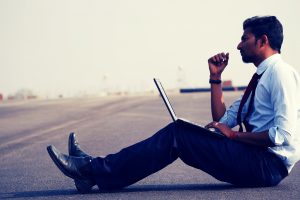 Man working on laptop at work site