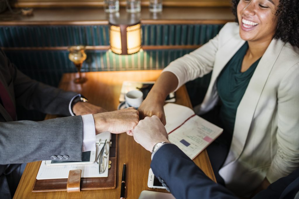 Woman shaking hands with client showing brand trust in business