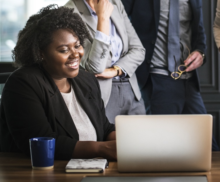 Business people reviewing project on laptop